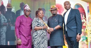 Madu flanked by dignitaries
